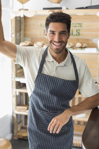 Closeup of a smiling male cafe owner in his apron
